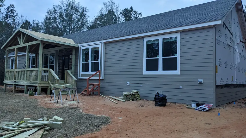 New home with a freshly framed gable porch and pressure-treated rails and steps