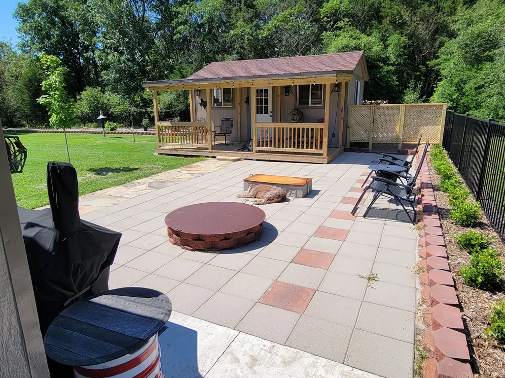 Paver patio with lattice screening and a covered porch structure